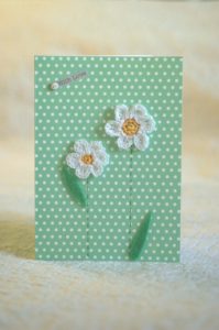 Hand made and hand stitched, white crocheted flowers and green felt leaves greetings card and 'With love' tag on front. Left blank inside for your own message. Size w12.7 x h17.7cm