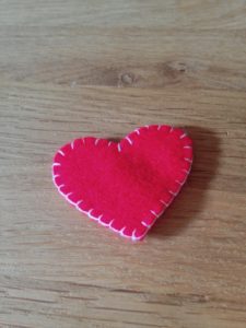 Red hand sewn felt heart brooch.