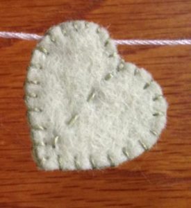 Pale green hand sewn felt heart.