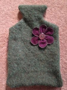 Recycled green jumper, water bottle cover with purple cord flower brooch. 