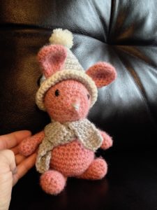 Little  pink alpaca wool crocheted bunny with grey and white winter hat and scarf.