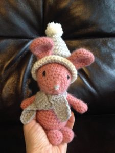 Little  pink alpaca wool crocheted bunny with grey and white winter hat and scarf.