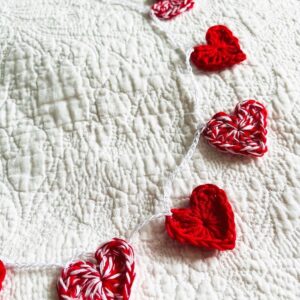 A garland of 11 red and white and solid red crocheted cotton hearts, on a white cotton chain. Approximately 110cm length. Each heart measures approximately 3.5cm width x 3cm height. This is a decoration only, and is NOT a toy. Keep out of the reach of babies and small children due to the small parts and risk of choking.