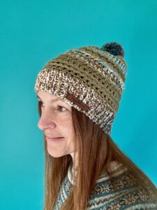 A soft and chunky textured hat with a large detachable bobble. Made in a khaki green yarn and a complimentary mix of cream, brown, grey and turquoise. 
Both yarns are very soft and chunky, yet lightweight and warm.
The yarn is made  of 100% Acrylic which makes it extremely wearable and machine washable too. 
The label is made from 100% Polyurethane so is Vegan friendly.

This item is machine washable on a warm hand wash setting at 40c. 
Gently re-shape and dry flat.
Do Not tumble dry.
Do NOT iron.
