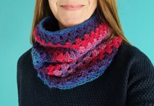 A handmade, block textured, crocheted neck warmer. Made using a soft and lightweight 70% acrylic/ 30% Wool mix yarn in a range of warm and vibrant jewel colours.