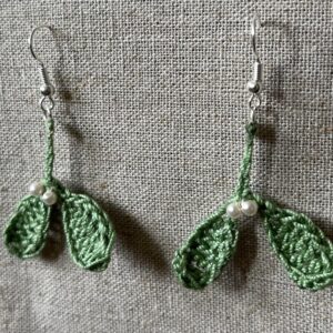 Hand made, crocheted, mini mistletoe earrings. Made using 100% cotton in soft green colour with glass pearl effect beaded details. The earring hooks are made from a silver plated brass and are nickel, lead and cadmium free. Each earring measures approximately 3cm wide by 5cm Height (including hook).