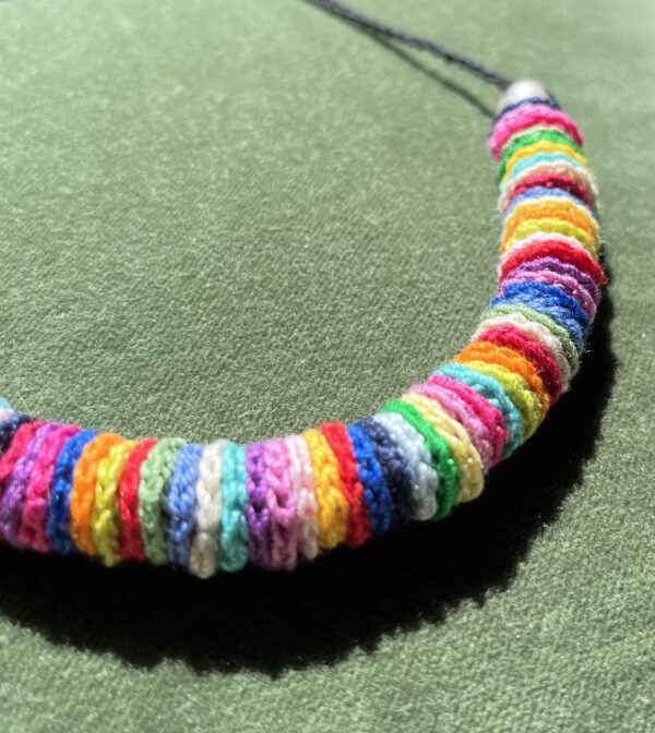 A handmade, crocheted necklace of multicoloured discs, made using 100% cotton and metal beads/fixings. No plastic has been used. This item is Vegan and Eco-friendly, reusable and fully recyclable.