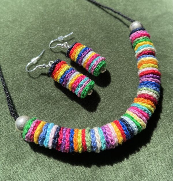 A handmade, crocheted necklace of multicoloured discs, made using 100% cotton and metal beads/fixings. No plastic has been used. This item is Vegan and Eco-friendly, reusable and fully recyclable.