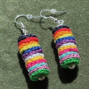 A handmade, crocheted pair of earrings made of multicoloured discs, made using 100% cotton and glass beads and metal fixings. The earring hooks are made from a silver plated brass and are nickel, lead and cadmium free. Each earring measures approximately 1.2cm wide by 5cm Height (including hook). No plastic has been used. This item is Vegan and Eco-friendly, reusable and fully recyclable.