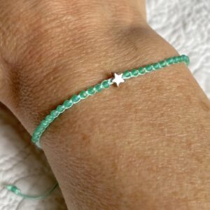 A handmade, single stranded beaded bracelet with silver star. Made using 100% cotton and glass and metal beads/fixings. This item is fully adjustable. No plastic has been used. This item is Vegan and Eco-friendly, reusable and fully recyclable.