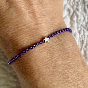 A handmade, single stranded beaded bracelet with silver star. Made using 100% cotton and glass and metal beads/fixings. This item is fully adjustable. No plastic has been used. This item is Vegan and Eco-friendly, reusable and fully recyclable.