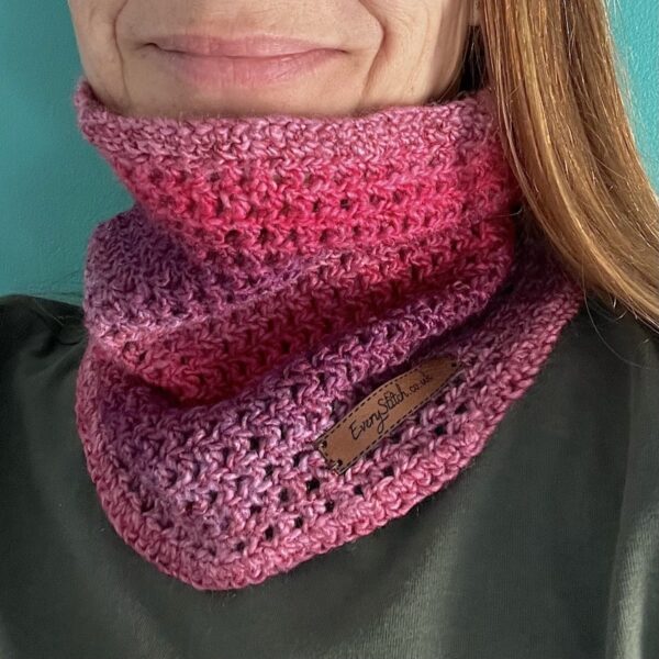 A soft and delicate textured neck warmer. Made in a vibrant mix of red, pink, and purple shades, using a very soft and lightweight Acrylic yarn.