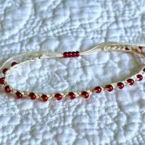 A handmade, crocheted, fully adjustable, single stranded bracelet. Made using glass beads and 100% cotton. No plastic!