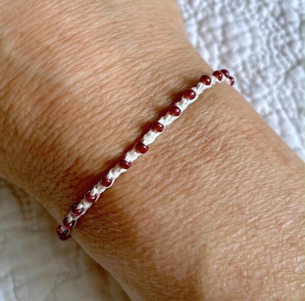 A handmade, crocheted, fully adjustable, single stranded bracelet. Made using glass beads and 100% cotton. No plastic!