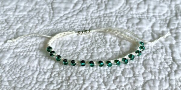 A handmade, crocheted, fully adjustable, single stranded bracelet. Made using glass and metal beads and 100% cotton. No plastic!